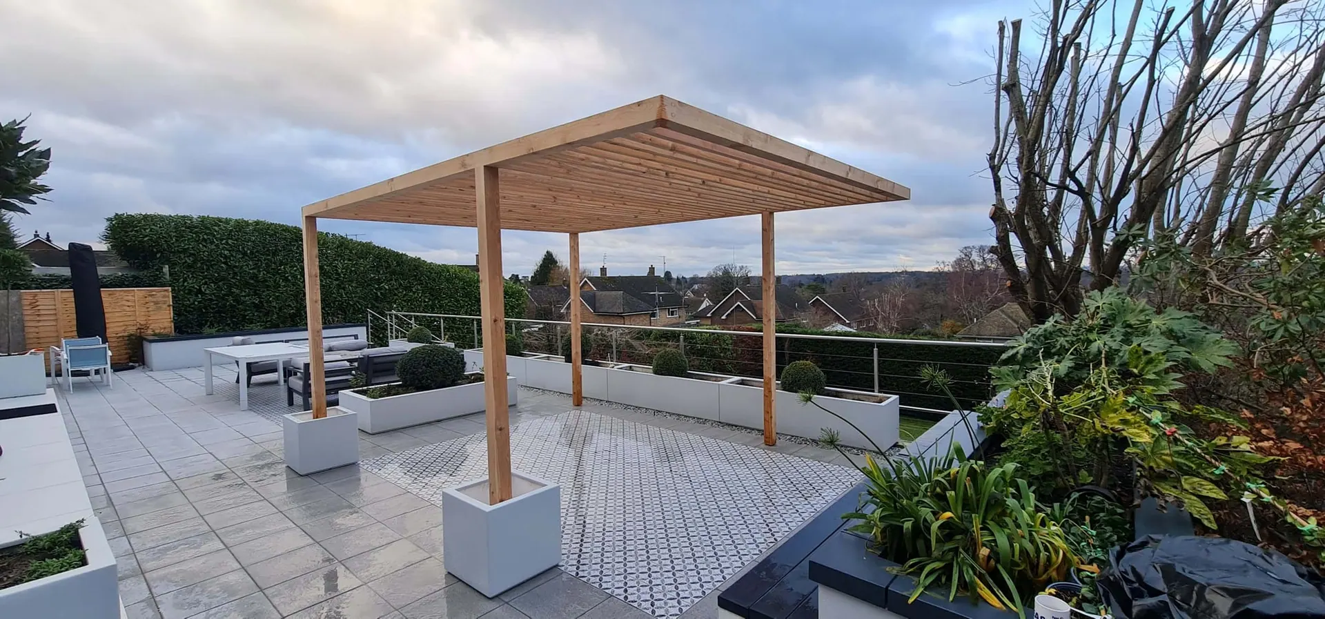 Timber pergola over a paved roof terrace